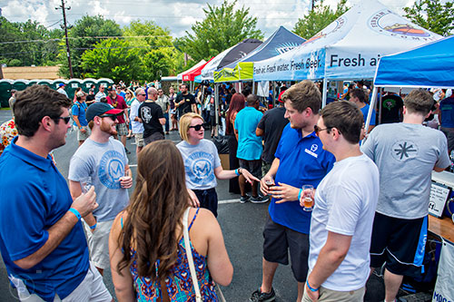 Thomas Pratt (left), Austin Smith, Maddy Kearns, Lena Thompson, Andy Motz and Adam Hollingsworth talk during the Georgia Craft Beer Festival outside of Red Brick Brewing in Atlanta on Saturday, May 30, 2015. 