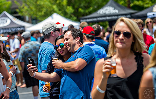 Hala Bailey (left) and her husband Mark take a selfie during the Georgia Craft Beer Festival outside of Red Brick Brewing in Atlanta on Saturday, May 30, 2015. 