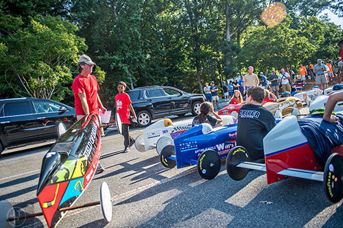 Byron Pearch (left) places a last minute entry into the line of cars before the start of the All American Dunwoody Soap Box Derby at the First Baptist Church of Atlanta in Dunwoody on Saturday, June 6, 2015. 