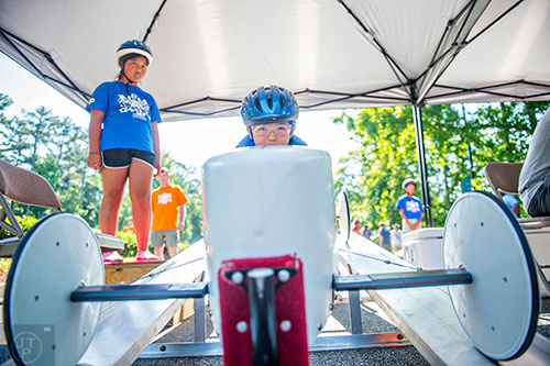 Soma Hall (center) sits ready at the starting line during the All American Dunwoody Soap Box Derby at the First Baptist Church of Atlanta in Dunwoody on Saturday, June 6, 2015. 