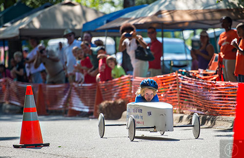 Addy Williams speeds down her lane during the All American Dunwoody Soap Box Derby at the First Baptist Church of Atlanta in Dunwoody on Saturday, June 6, 2015. 