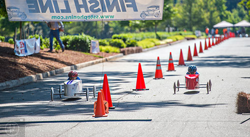 Racers near the finish line during the All American Dunwoody Soap Box Derby at the First Baptist Church of Atlanta in Dunwoody on Saturday, June 6, 2015. 