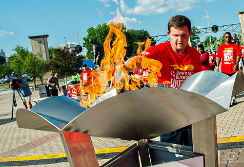 Will Crain (right), a special olympian from Hall County, lights the cauldron with the Flame of Hope after carrying it into Turner Field in Atlanta during the Unified Relay Across America on Saturday, June 6, 2015. 