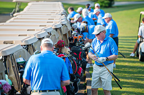 Bobby "Skippack" Jones (right) from Skippack, PN grabs his clubs to warm up before competing in the Bobby Jones Open golf tournament at Braelinn Golf Club in Peachtree City on Tuesday, June 9, 2015. 