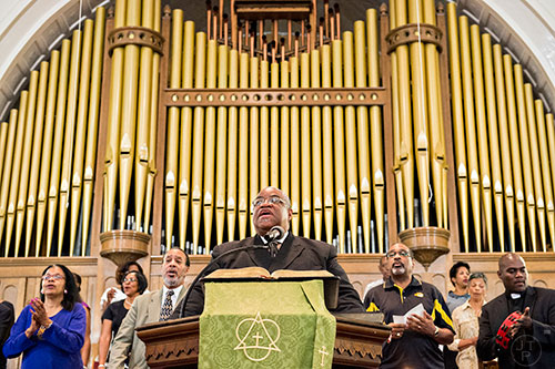 Reverand John Foster, Ph.D. (center) leads the Prayer, Healing and Reconciliation Service for members of the Emanuel A.M.E. Church in Charleston, South Carolina who lost their lives earlier this week at Big Bethel A.M.E. Church in Atlanta on Friday, June 19, 2015. 