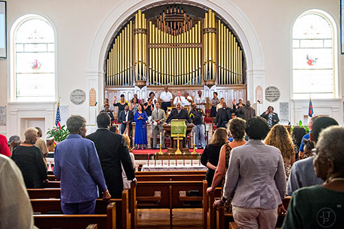 Rev. John Foster, Ph.D. (center) leads the Prayer, Healing and Reconciliation Service for members of the Emanuel A.M.E. Church in Charleston, South Carolina who lost their lives earlier this week at Big Bethel A.M.E. Church in Atlanta on Friday, June 19, 2015.  