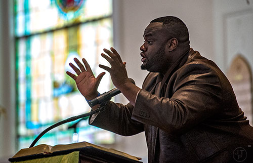 Rev. Kewon Foster (center) speaks during the Prayer, Healing and Reconciliation Service for members of the Emanuel A.M.E. Church in Charleston, South Carolina who lost their lives earlier this week at Big Bethel A.M.E. Church in Atlanta on Friday, June 19, 2015. 