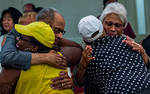 McDonald Williams (left) and his wife Jamye hug fellow church members during the Prayer, Healing and Reconciliation Service for members of the Emanuel A.M.E. Church in Charleston, South Carolina who lost their lives earlier this week at Big Bethel A.M.E. Church in Atlanta on Friday, June 19, 2015.  