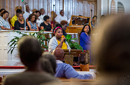 Aurielle Marie (center) speaks during the Prayer, Healing and Reconciliation Service for members of the Emanuel A.M.E. Church in Charleston, South Carolina who lost their lives earlier this week at Big Bethel A.M.E. Church in Atlanta on Friday, June 19, 2015.  