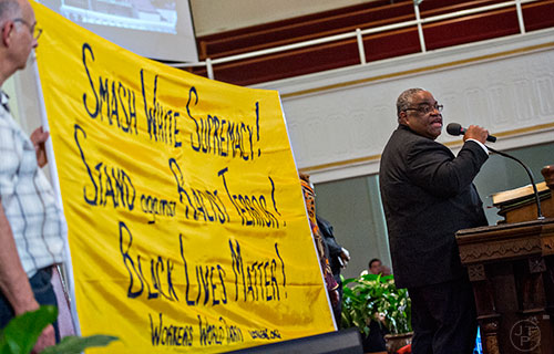 Rev. John Foster, Ph.D. (right) leads the Prayer, Healing and Reconciliation Service for members of the Emanuel A.M.E. Church in Charleston, South Carolina who lost their lives earlier this week at Big Bethel A.M.E. Church in Atlanta on Friday, June 19, 2015. 