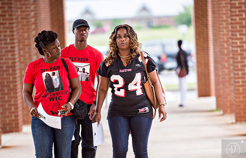 Latoscha Brown (right) walks with Ebony Pearson (left) as they arrive for the memorial service for Brown's son Wali Clanton Jr. at Dutchtown High School in Hampton on Thursday, June 18, 2015. 