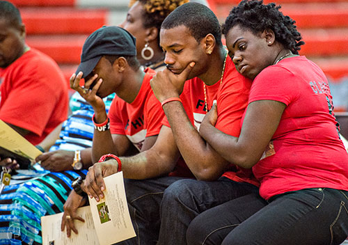 Kimberly Ross (right) holds onto Gregory Powell as they and Andre Grimsley grieve during Wali Clanton Jr's. memorial service at Dutchtown High School in Hampton on Thursday, June 18, 2015.