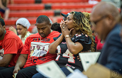 Latoscha Brown (center) covers her face with her hands during the memorial service for her son Wali Clanton Jr.at Dutchtown High School in Hampton on Thursday, June 18, 2015.