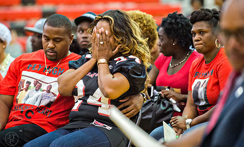 Latoscha Brown (center) covers her face with her hands during the memorial service for her son Wali Clanton Jr.at Dutchtown High School in Hampton on Thursday, June 18, 2015. 