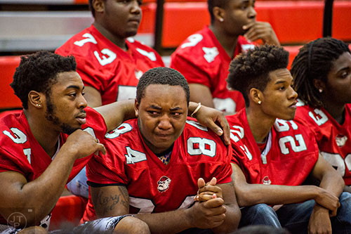 Shawn Odom (left) comforts Lewis Howard during the memorial service for Wali Clanton Jr. at Dutchtown High School in Hampton on Thursday, June 18, 2015. 