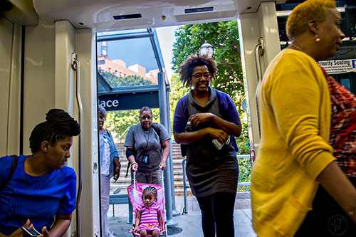 Passengers board an Atlanta Streetcar at the Park Place stop in downtown.