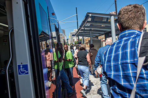 Passengers leave and board an Atlanta Streetcar at the Sweet Auburn Market stop in downtown.