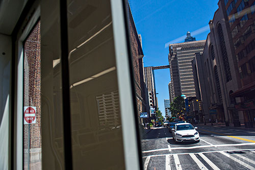 Traffic stops as an Atlanta Streetcar makes a turn as it pulls out of the Carnegie at Spring stop in downtown.