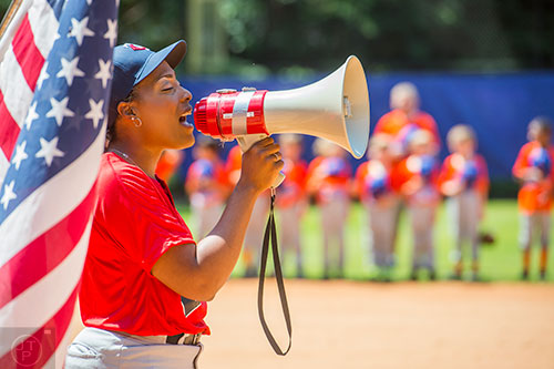 Artesha Chaney uses a bullhorn as she sings the national anthem during the ceremony for the opening day of Decatur Youth Baseball at Oakhurst Park on Saturday, June 6, 2015.