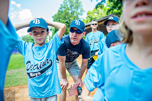 Coach Brett Duke (center) talks to his team as the ceremony for the opening day of Decatur Youth Baseball comes to a close at Oakhurst Park on Saturday, June 6, 2015.