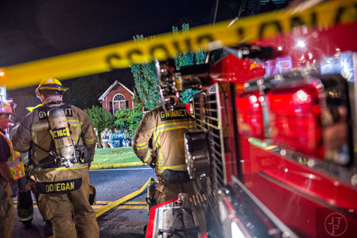 Gwinnett County firefighters extinguish a fire at 805 Hiram Davis Rd. in Lawrenceville on Wednesday, June 17, 2015.