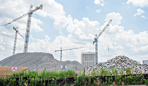 Cranes rise into the air as construction continues on the new SunTrust Park, the new home of the Atlanta Braves, from Windy Ridge Parkway on Thursday, June 18, 2015.