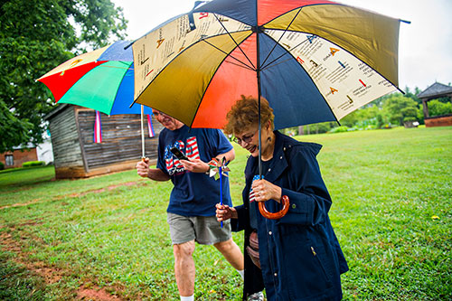 Suzanne Huseman (right) and her husband Joe walk the grounds during the inaugural BBQ & Bluegrass at Barrington Hall in Roswell on Saturday, July 4, 2015. 