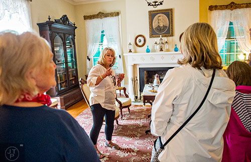 Sue Gray (center) leads a tour during the inaugural BBQ & Bluegrass at Barrington Hall in Roswell on Saturday, July 4, 2015. 