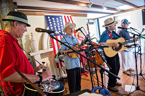 Mike Hughes (left), Reuben Fair, Kim Fair, Walter Stark and Jim Coleman with the band SmokeRise perform during the inaugural BBQ & Bluegrass at Barrington Hall in Roswell on Saturday, July 4, 2015. 