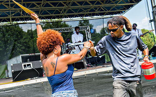 Donny James (right) dances with Patti Jackson as Gritz & Jelly Butter performs on stage during the Atlanta Street Food Festival at Piedmont Park in Atlanta on Saturday, July 11, 2015. 