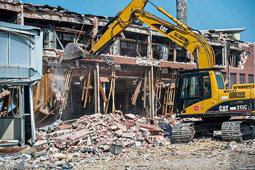 An excavator demolishes one of two remaining buildings that still stand at the GM Plant in Doraville on Monday, June 29, 2015.