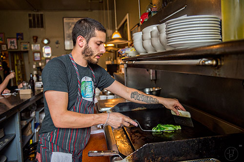 Chef Jarrett Stieber (center) on the grill during Eat Me Speak Me at Gato off of McLendon Ave. in Atlanta on Friday, July 3, 2015.