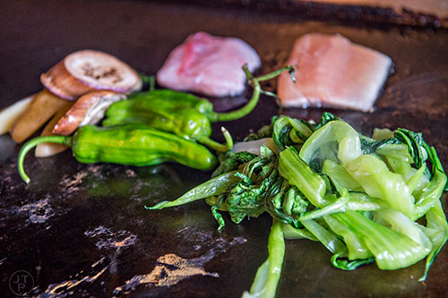 Bok choi, duck, trout and other yummy ingredients on the grill during Eat Me Speak Me at Gato off of McLendon Ave. in Atlanta on Friday, July 3, 2015.