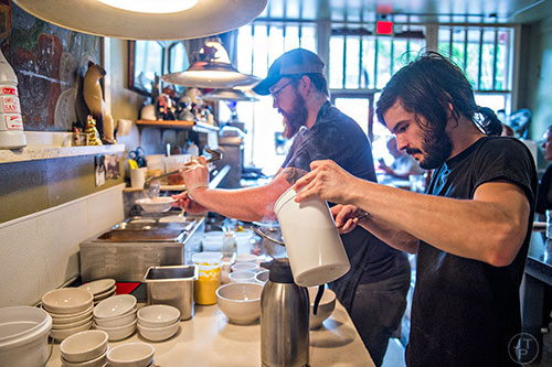 Gage Gilmore (right) and Dut Goodman work together to fill orders during Eat Me Speak Me at Gato off of McLendon Ave. in Atlanta on Friday, July 3, 2015.
