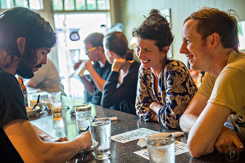 Gage Gilmore (left) takes an order during Eat Me Speak Me at Gato off of McLendon Ave. in Atlanta on Friday, July 3, 2015.
