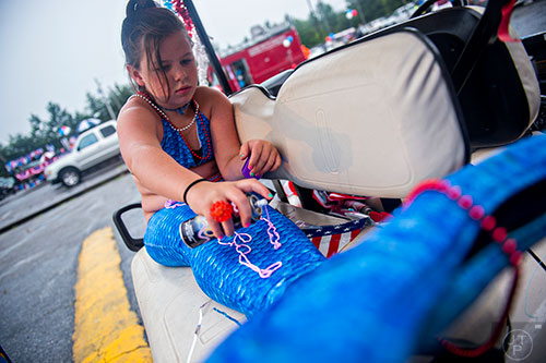 Lilly Newman sprays silly string all over her mermaid tail before the start of the Avondale Estates 4th of July Parade on Saturday. 