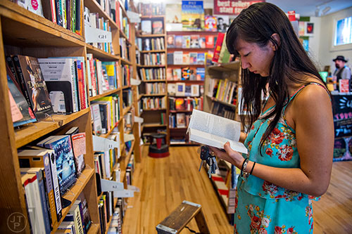 Aisha Guthrie thumbs through a book at A Cappella bookstore in Atlanta on Monday, June 29, 2015. Frank Reiss is the owner of the independent book store that has been an Atlanta staple for decades. 