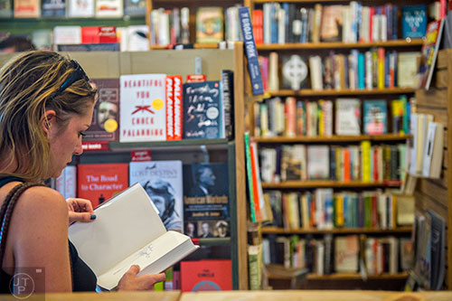 Katie Ellis thumbs through a book at A Cappella bookstore in Atlanta on Monday, June 29, 2015. 