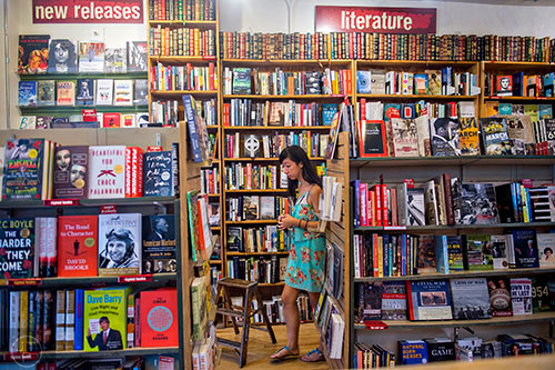 Aisha Guthrie passes by shelves of books as she looks for a new read at A Cappella bookstore in Atlanta on Monday, June 29, 2015. 