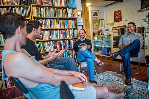 Author Jesse Goolsby (right) talks about his new book with Frank Reiss, Jamie Badoud and Christian Bradley West at A Cappella bookstore in Atlanta on Monday, June 29, 2015. 