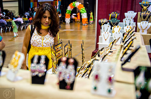 Mayuri Ray (center) looks at jewelry during the Festival of India at the Gwinnett Center in Duluth on Saturday, August 22, 2015. 