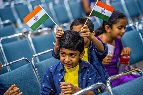 Prithvi Veliyath (center) has two Indian flags held to his head by Kailish Sreekanth during the Festival of India at the Gwinnett Center in Duluth on Saturday, August 22, 2015. 
