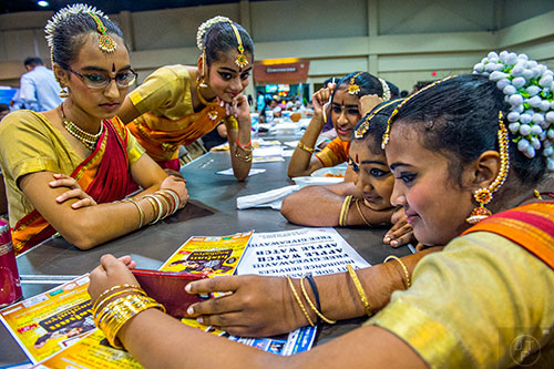 Yumin Shivdasani (left), Keya Parikh, Pallavi Eranezhath, Aarushi Vadhula and Linda Jawahar watch a video of their performance during the Festival of India at the Gwinnett Center in Duluth on Saturday, August 22, 2015.