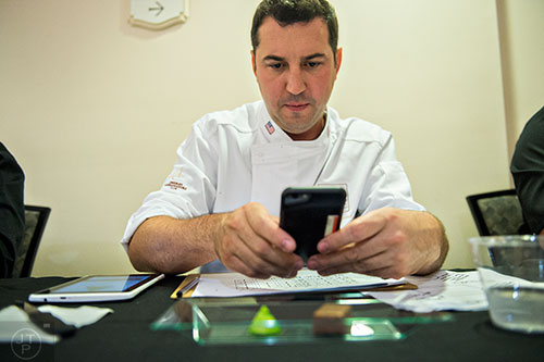 World renowned pastry chef Rocco Lugrine (center) takes a photo of one of the entries in the Chocolatier of the Year competition during Pastry Live 5 at 200 Peachtree in Atlanta on Sunday, August 23, 2015. 
