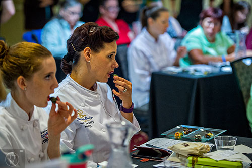 Cher Harris (center) and Emily Holtz taste one of the entries in the Chocolatier of the Year competition during Pastry Live 5 at 200 Peachtree in Atlanta on Sunday, August 23, 2015. 