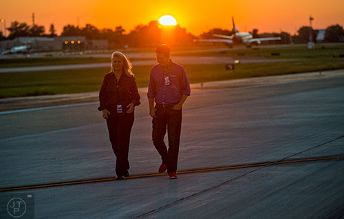 Kim Wade (left) and Reese McCranie look for foreign object debris as they walk down runway 8L/26R at Hartsfield Jackson Atlanta International Airport during the 14th annual FOD Walk on Wednesday, August 26, 2015. 