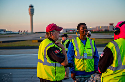John Donehoo (left) talks with Chandra Mills and Meese Watson after walking runway 8L/26R at Hartsfield Jackson Atlanta International Airport during the 14th annual FOD Walk on Wednesday, August 26, 2015.