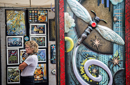 Arlene Klostermann walks through H.C. Warner's booth during the 13th annual Grant Park Summer Shade Festival on Saturday, August 29, 2015. 