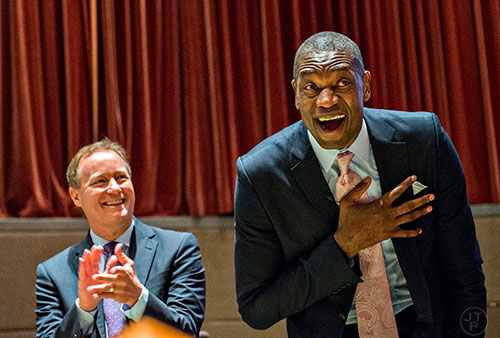 Dikembe Mutombo (right) reacts to the announcement that his jersey number will be retired on November 24 as Atlanta Hawks coach Mike Budenholzer claps during the celebration naming September 1 as Dikembe Mutombo Day in Fulton County at the Fulton County Government Center in Atlanta on Tuesday, September 1, 2015.   