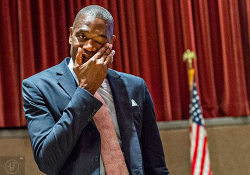 Dikembe Mutombo wipes tears from his eyes after the announcement that his jersey number will be retired on November 24 during the celebration naming September 1 as Dikembe Mutombo Day in Fulton County at the Fulton County Government Center in Atlanta on Tuesday, September 1, 2015.   